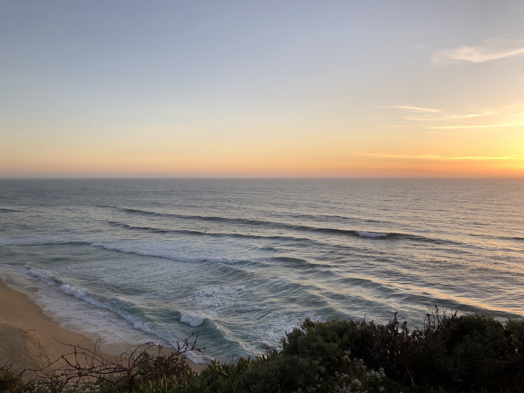Sunset over the Pacific from a bluff above the beach